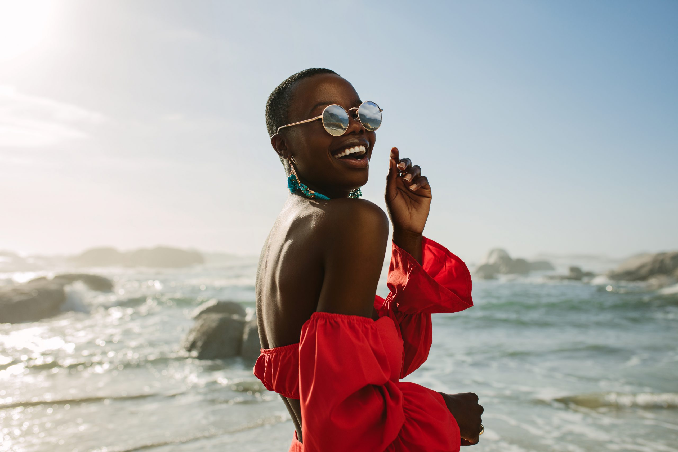beautiful black woman laughing on the beach