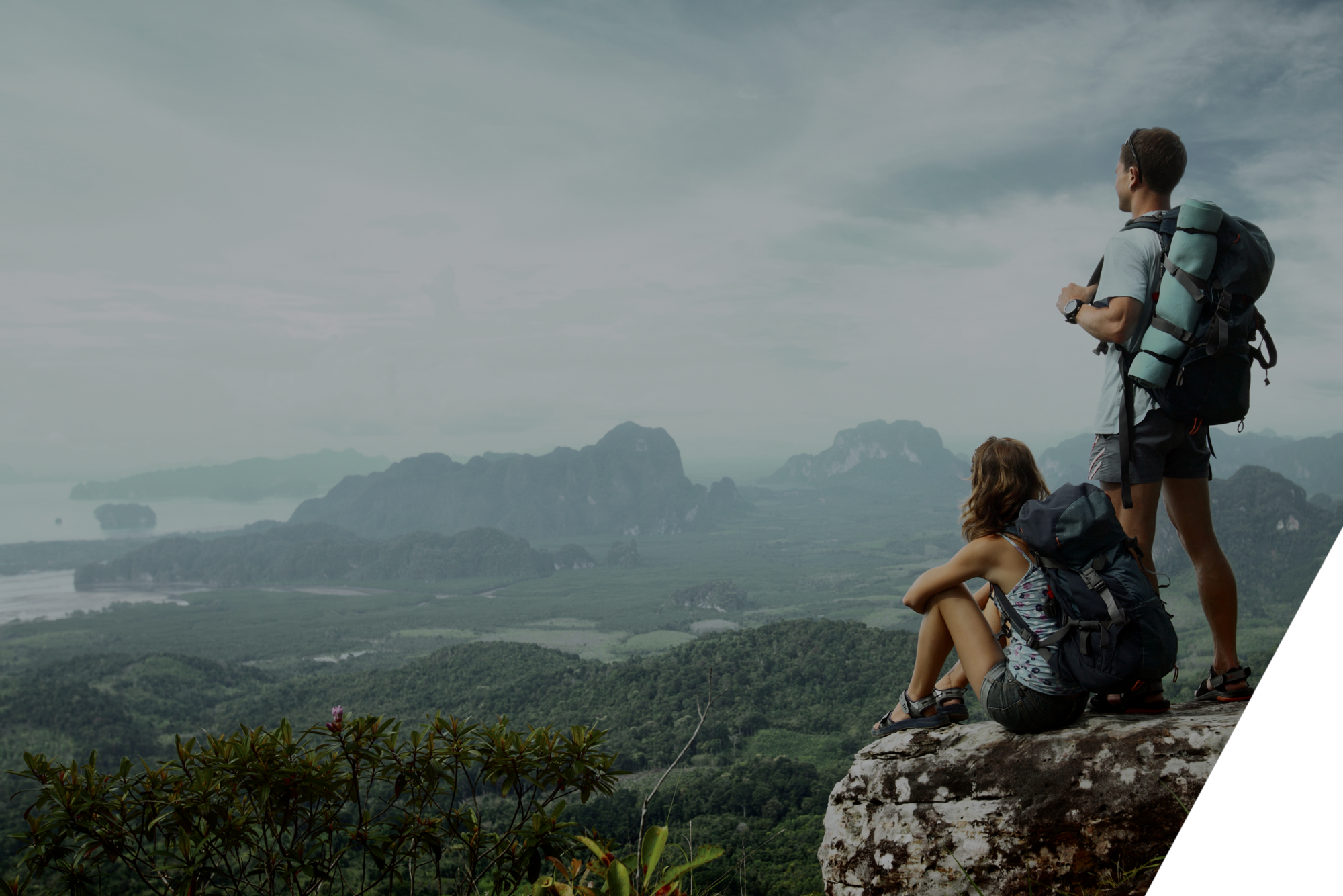 couple on top of hill overlooking mountains and valleys