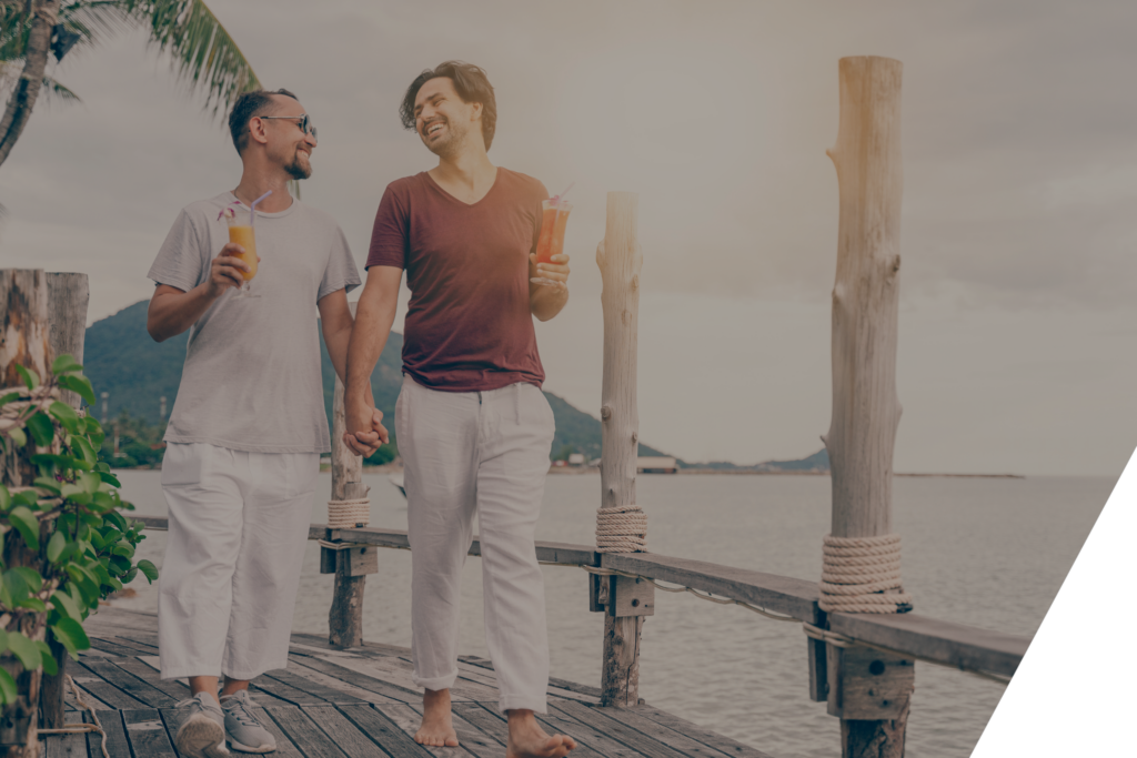 gay couple walking on a pier