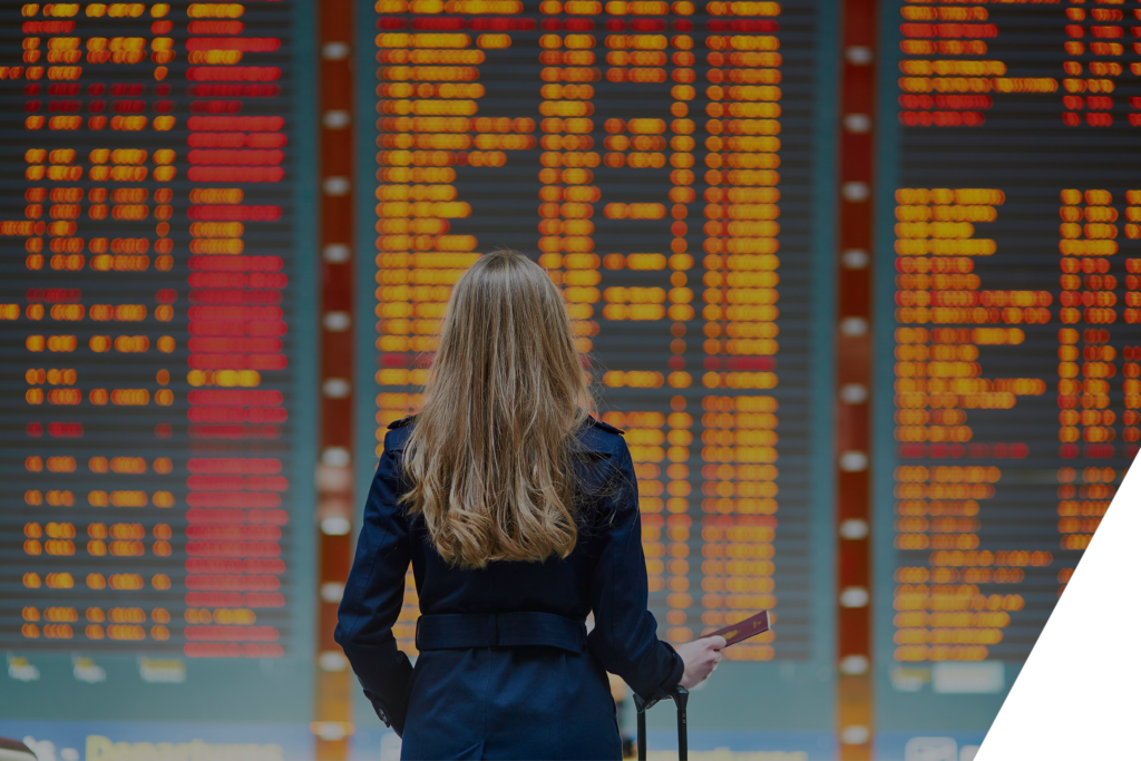 woman looking at flight schedule in the airport