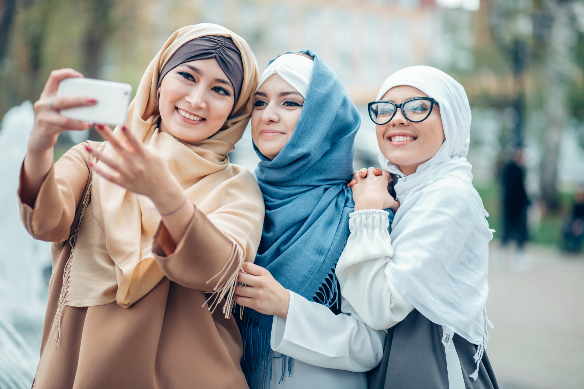 three middle eastern young women taking a picture